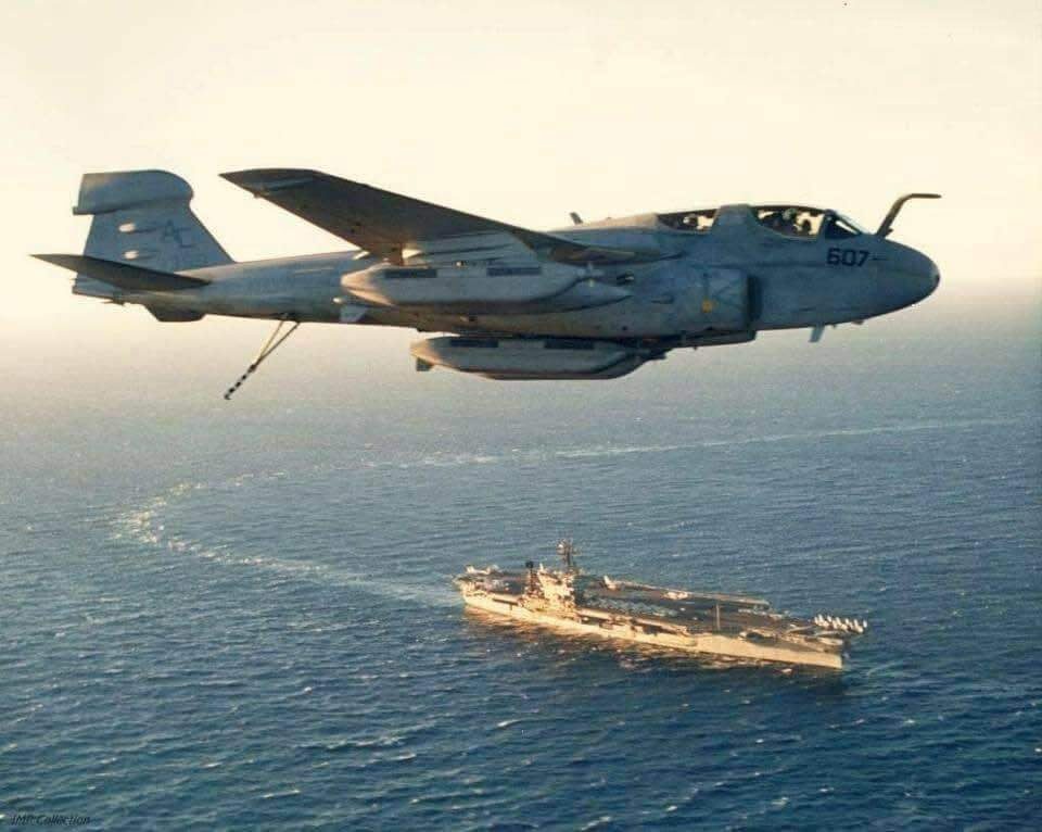 EA-6B Prowler flying over a U.S. Navy aircraft carrier at sea